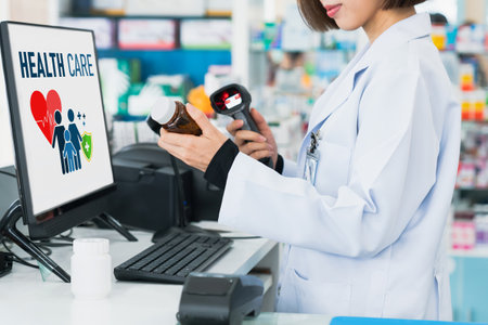 Closeup young pharmacist scanning the barcode of a mockup qualified pharmaceutical, medicine pill container or bottle for copyspace at pharmacy.の写真素材