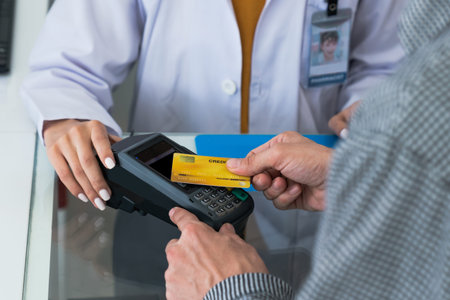 Payment by credit card with payment terminal in qualified drugstore or hospital. Modern payment of...