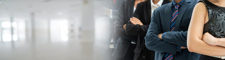 Successful business people standing together widen out showing strong relationship of worker community. A team of businessman and businesswoman expressing a strong group teamwork at the modern office.の写真素材