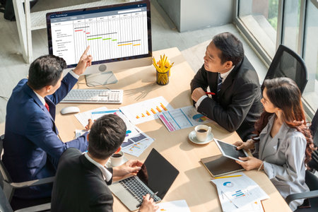 Project planning software for modish business project management on the computer screen showing timeline chart of the team projectの写真素材