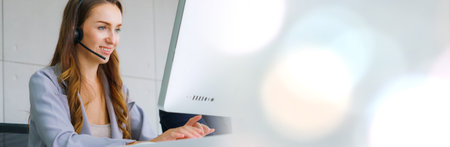Business people wearing headset working in office in widen view to support remote customer or...