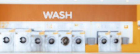 Blur background of of qualified coin-operated washing machines in a public store. Concept of a self...