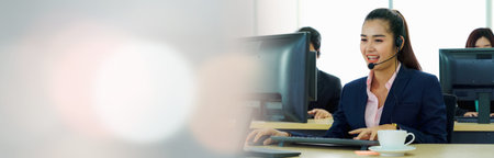 Business people wearing headset working in office in widen view to support remote customer or...