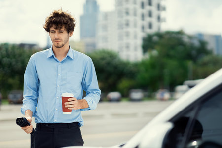 Progressive eco-friendly concept of parking EV car at public electric-powered charging station in city with blur background of businessman leaning on recharging-electric vehicle with coffee.の写真素材