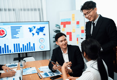 Business team of financial data analysis meeting with business intelligence, report paper and dashboard on laptop for marketing strategy. Business people working together to promote harmony in office.の写真素材