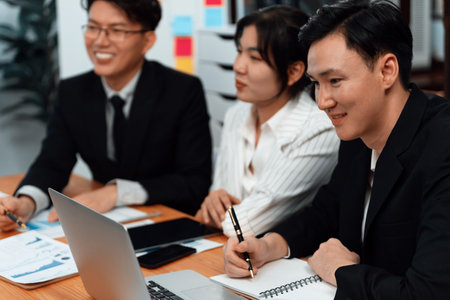 Business team of financial data analysis meeting with business intelligence, report paper and dashboard on laptop for marketing strategy. Business people working together to promote harmony in office.の写真素材