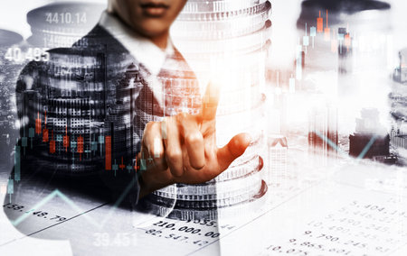 Businessman analyst working with digital finance business data graph showing technology of investment strategy for perceptive financial business decision. Digital economic analysis technology concept.の写真素材