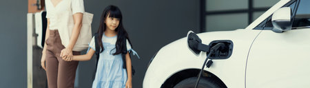 Progressive lifestyle of mother and daughter who have just returned from school in an electric...