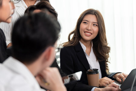 Focus portrait of female manger, businesswoman in the harmony meeting room with blurred of colleagues working together, analyzing financial paper report and dashboard data in background.の写真素材