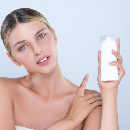 Alluring beautiful perfect cosmetic skin woman portrait hold mockup tube cream or moisturizer for skincare treatment, anti-aging product in isolated background. Natural healthy skin model concept.の写真素材