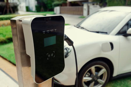 Focus electric home charging station powered from green energy at home for vehicle engine. Progressive eco friendly energy rechargeable for vehicle concept.の写真素材