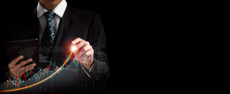 Businessman analyst working with digital finance business data graph showing technology of investment strategy for perceptive financial business decision. Digital economic analysis technology concept.の写真素材