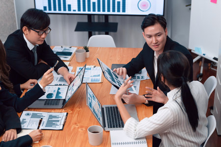 Business team of financial data analysis meeting with business intelligence, report paper and dashboard on laptop for marketing strategy. Business people working together to promote harmony in office.の写真素材