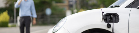 Progressive eco-friendly concept of focus parking EV car at public electric-powered charging station...