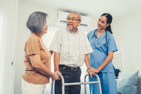 Contented senior man was helped on folding walking by his wife and caregiver. Recuperation for elderly, seniors care, nursing home.の写真素材