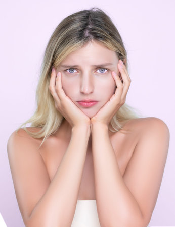 Alluring portrait of beautiful woman feel insecure on her facial skin, oily or acne problem. Worried...