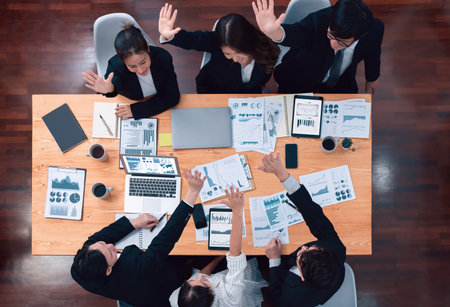 Top-view business team of financial data analysis meeting with business intelligence, report paper and dashboard on laptop for marketing strategy. Business people working together in office of harmonyの写真素材
