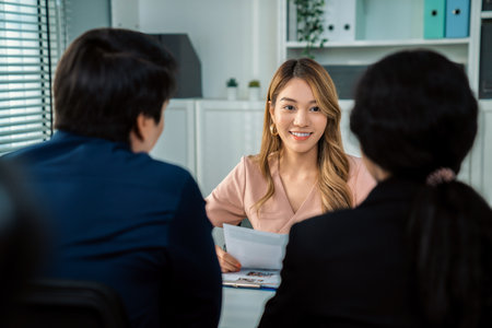 A young female asian candidate tries to impress her interviewer by being competent. International company, multicultural environment in workplace.の写真素材