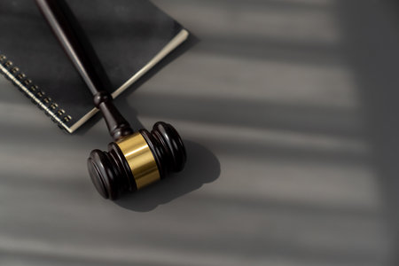 Top view black wooden gavel hammer and law book on wooden office desk background as justice and legal system for lawyer and judge, Legal authority and fairness in trials concept. equilityの写真素材