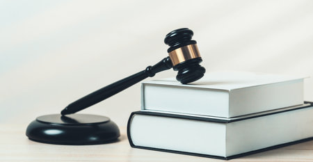Closeup wooden gavel hammer and law book in empty law firm or white lawyer office background as justice and legal system by lawyer and judge, Legal authority and fairness in trial concept. equilityの写真素材