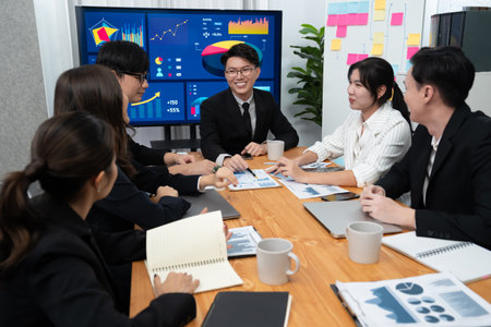 Business team of financial data analysis meeting with business intelligence, report paper and dashboard on laptop for marketing strategy. Business people working together to promote harmony in office.の写真素材