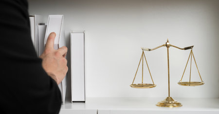 Lawyer or attorney preparing for lawsuit or litigation, reading or studying legal book at bookshelf or library for educational law school concept, decorated with legal symbols. Equilibriumの写真素材