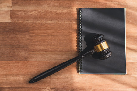 Top view black wooden gavel hammer and law book on wooden office desk background as justice and legal system for lawyer and judge, Legal authority and fairness in trials concept. equilityの写真素材
