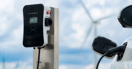 Progressive combination of wind turbine and EV car, future energy infrastructure. Electric vehicle...