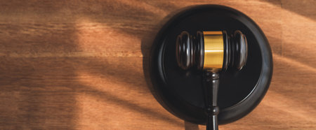 Closeup top view black wooden gavel hammer on wooden office desk background as justice and legal system for lawyer and judge, Legal authority and fairness in trials concept. equilityの写真素材