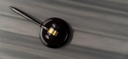 Closeup top view black wooden gavel hammer on wooden office desk background as justice and legal system for lawyer and judge, Legal authority and fairness in trials concept. equilityの写真素材