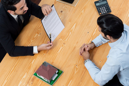 Top view real estate agent calculate tax and interest, discuss ownership term and insurance...