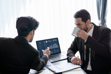 Busy analyst team discussing financial data on digital dashboard, analyzing chart and graph using data science software display on a laptop screen. Business intelligence and Fintech. Ferventの写真素材