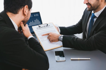 Interviewing job applicant in office with resume paper. Candidate wear suit for formal conversation with interviewer. Recruitment process with question about career and work experience. Ferventの写真素材