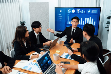 Business team of financial data analysis meeting with business intelligence, report paper and dashboard on laptop for marketing strategy. Business people working together to promote harmony in office.の写真素材
