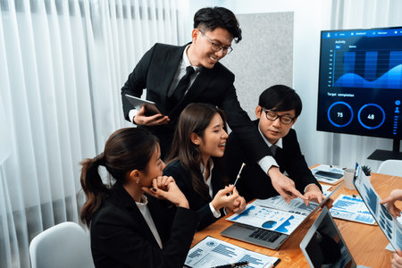 Business team of financial data analysis meeting with business intelligence, report paper and dashboard on laptop for marketing strategy. Business people working together to promote harmony in office.の写真素材