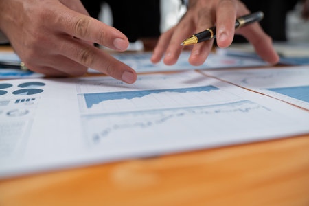Closeup busy analyst team discussing financial data on digital dashboard, analyzing chart and graph using data science software display on a laptop screen. Business intelligence and Fintech. Ferventの写真素材
