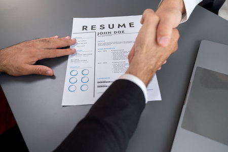 Successful job interview at business office with handshake. Positive discussion of qualifications and application for position. Job hiring concept between candidate and interviewer. Ferventの写真素材