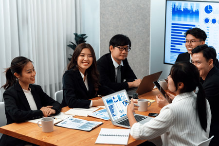 Business team of financial data analysis meeting with business intelligence, report paper and dashboard on laptop for marketing strategy. Business people working together to promote harmony in office.の写真素材