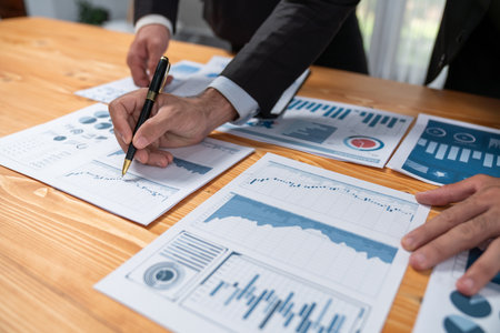 Closeup busy analyst team discussing financial data on digital dashboard, analyzing chart and graph using data science software display on a laptop screen. Business intelligence and Fintech. Ferventの写真素材