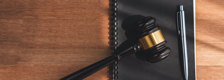 Top view black wooden gavel hammer and law book on wooden office desk background as justice and legal system for lawyer and judge, Legal authority and fairness in trials concept. equilityの写真素材