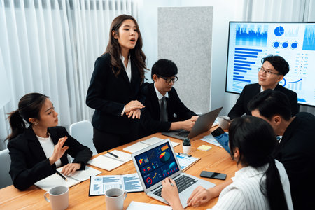 Business team of financial data analysis meeting with business intelligence, report paper and dashboard on laptop for marketing strategy. Business people working together to promote harmony in office.の写真素材