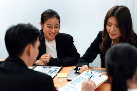 Business team of financial data analysis meeting with business intelligence, report paper and dashboard on laptop for marketing strategy. Business people working together to promote harmony in office.の写真素材