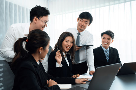 Harmony in office concept as business people analyzing dashboard paper together in workplace. Young colleagues give ideas at manager desk for discussion or strategy planning about project.の写真素材