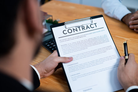 Focus house loan contract agreement with blurred client review legal document with real estate agent while discuss term and property ownership. Client reading agreement for making decision. Ferventの写真素材