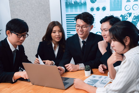 Business team of financial data analysis meeting with business intelligence, report paper and dashboard on laptop for marketing strategy. Business people working together to promote harmony in office.の写真素材