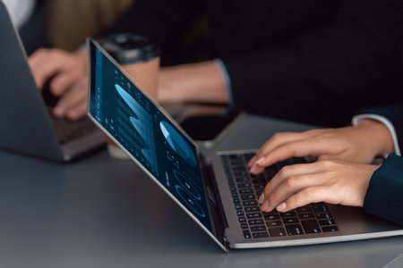 Business team analyze business analytic or business intelligence dashboard on laptop screen show graph and chart with statistic in harmony office. Analyst team meeting researching, planning strategy.の写真素材