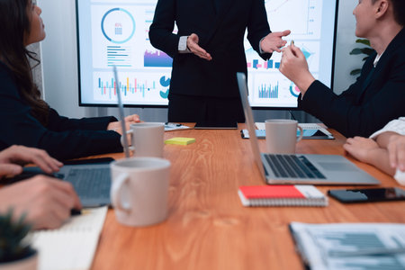 Confidence and asian businessman give presentation on financial analyzed by business intelligence in...