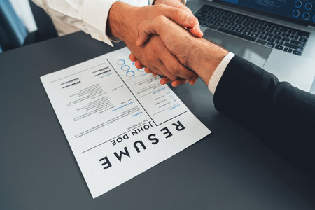 Successful job interview at business office with handshake. Positive discussion of qualifications and application for position. Job hiring concept between candidate and interviewer. Ferventの写真素材