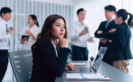 Focus portrait of female manger, businesswoman in the harmony meeting room with blurred of colleagues working together, analyzing financial paper report and dashboard data in background.の写真素材