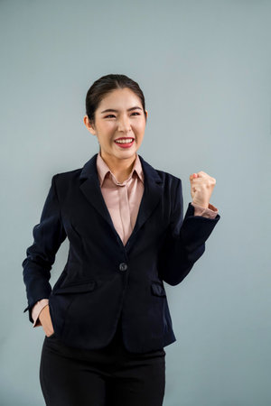 Confident young asian businesswoman in formal suit making hand gesture to indicate promotion or...